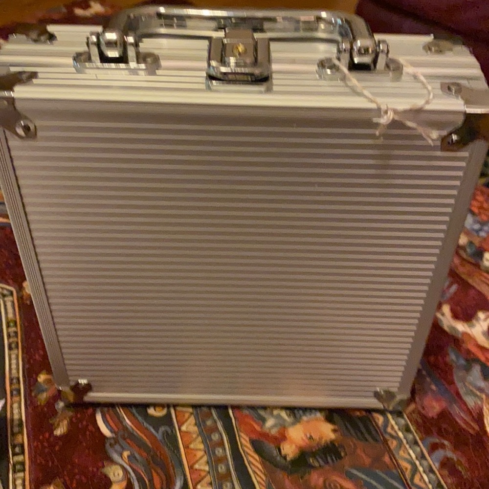Poker chips, cards, and dice in metal case